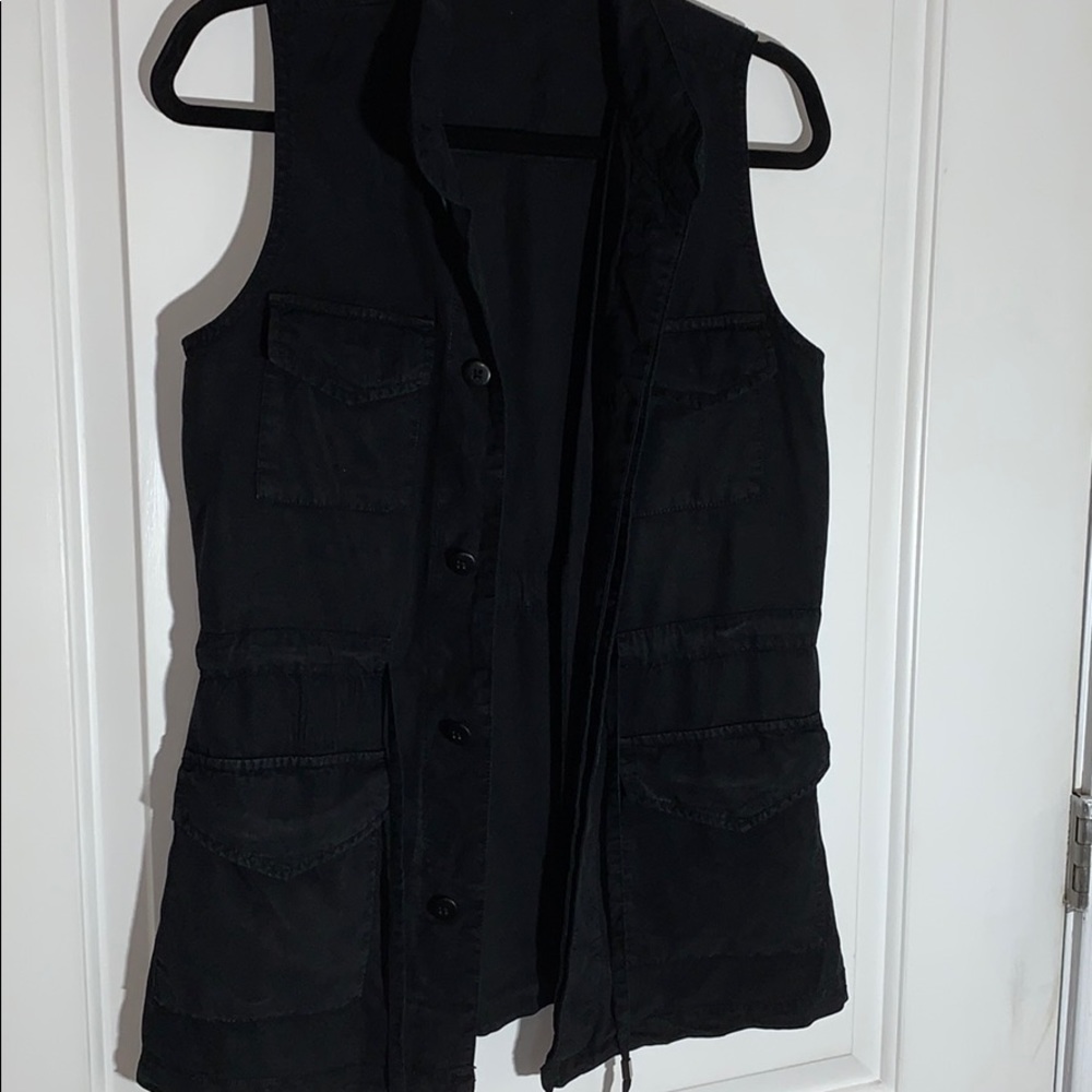 Black vest with pockets, tie, and hidden buttons